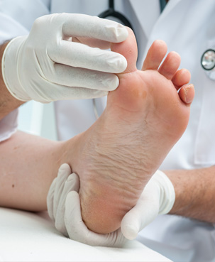 a doctor examining a foot, diabetic care